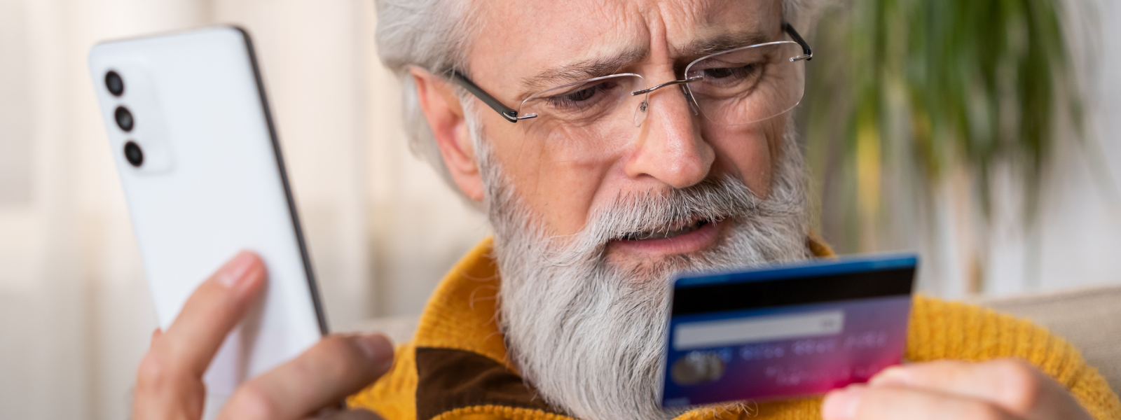 A person holding a credit card and phone.