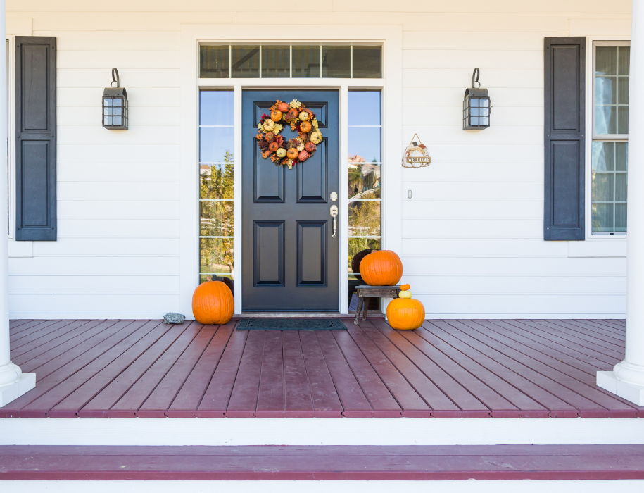 A front porch of a house with a wreath on the front door